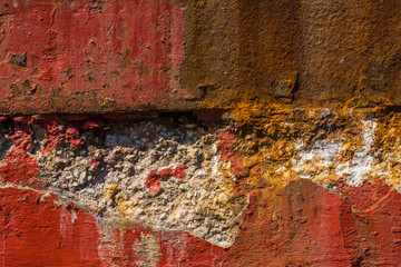 Old, worn, weathered, red painted, rusted concrete.