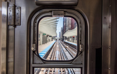 view of Washington/Wabash station through the window at the back of a Chicago EL train.