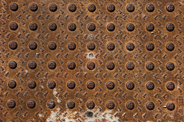 rusted metal textured dome pattered drainage cover on the street, Chicago Illinois