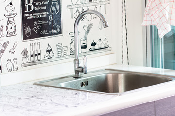 Water tap with sink in modern kitchen.