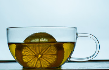 Tea with lemon in a transparent mug