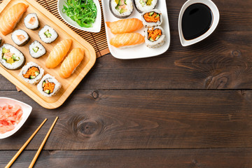 Fototapeta na wymiar Japanese sushi served on wooden background