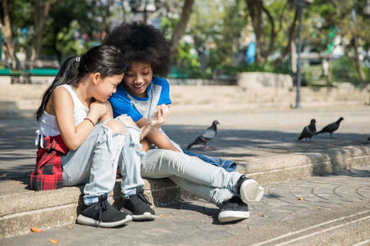 Two girls watching a video on phone together