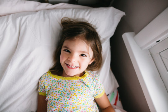 little girl wakes up in morning