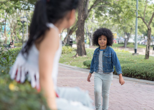 Two girls talking in a park