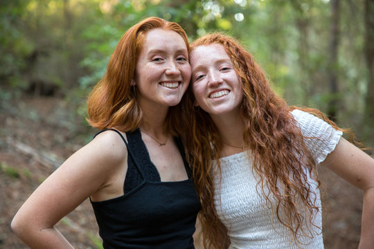 Beautiful redhead sisters in the forest