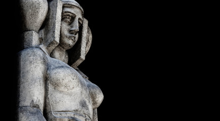 Goddess Hera is eldest daughter Kronos and Rei, sister and wife of Zeus. Ancient statue isolated on black background.