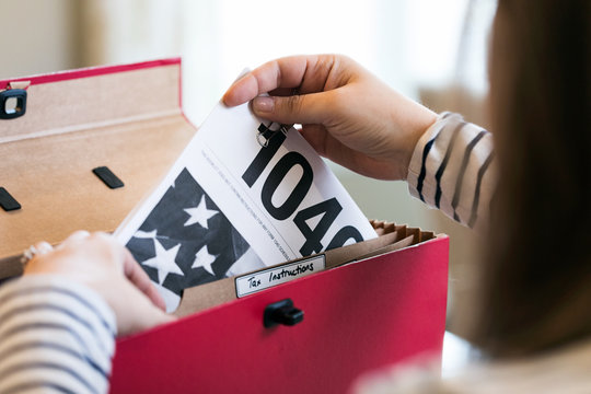 Taxes: Taking Instructions For 1040 Form Out Of Folder
