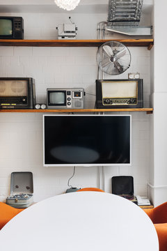 Retro TVs and Radios on Shelves in Bright Conference Room