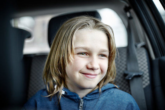 Teenage boy sitting in a car