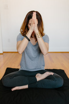 Beautiful woman practicing meditation at home