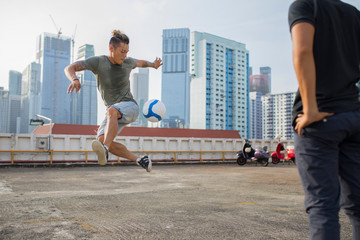 Two freestyle footballer on a rooftop