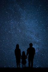 Happy family look at night sky