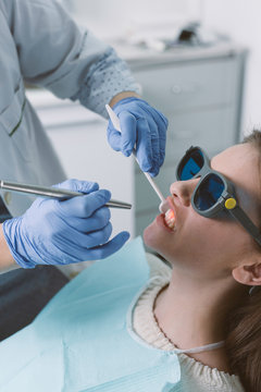 Woman getting a laser treatment, healing gums