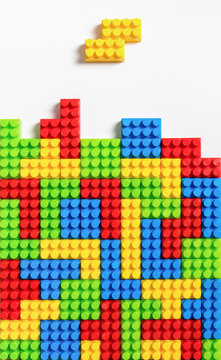 Colorful tetrominos made of colorful plastic building bricks
