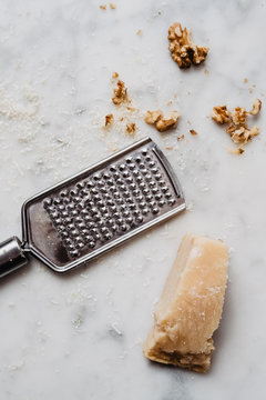 Parmesan and walnuts on marble background