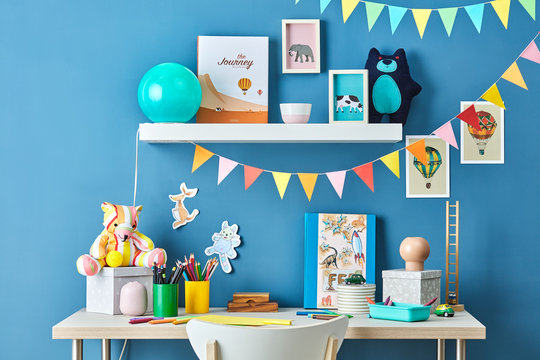 Kid's study with garlands, pictures and toys.