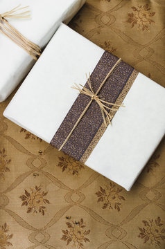 Two Christmas presents on vintage rust fabric background