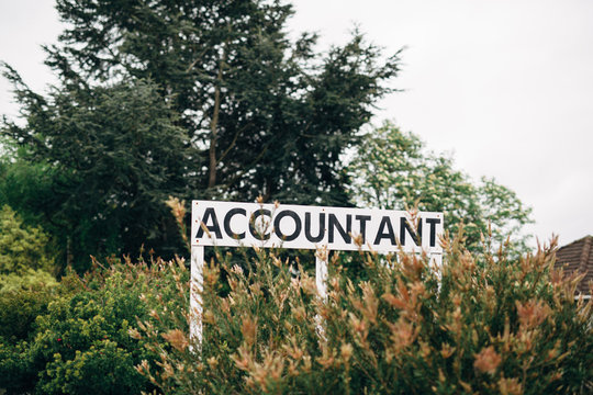 Accountant sign in bushes