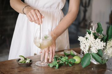 Crop woman mixing cocktail