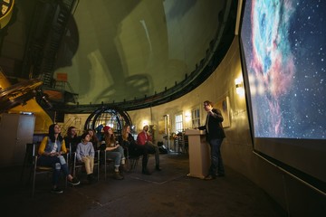 Tour group telescope in observatory