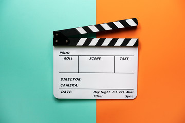 movie clapper on color table background; film, cinema and video photography concept - obrazy, fototapety, plakaty