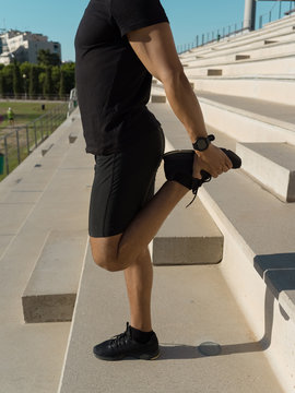 Crop sportsman flexing legs