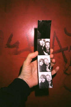 Photobooth strip of a young couple in hand