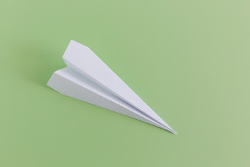 Paper airplane on green background. Travel concept.
