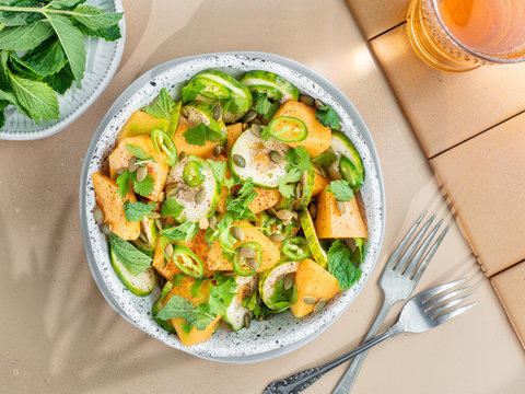 Refreshing, healthy, and organic fruit salad made with cantaloupe, cucumber, mint, cilantro, serrano peppers, coriander, cardamom, salt, pepper, sumac, and roasted pumpkin seeds.