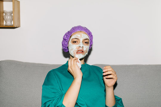 Woman taking off peeling mask