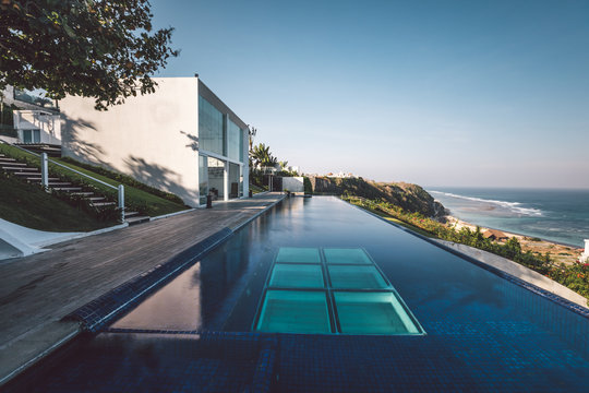 modern luxury property with huge swimming pool on a cliff with ocean view