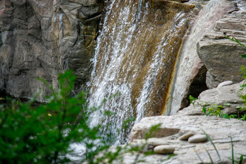Forests, streams and rocks - the beauty of nature. Waterfall in the Kiev zoo. Close-up