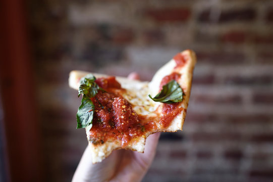 Point of view eating a slice of New York pizza