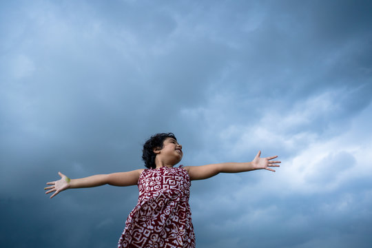 Little girl enjoying a cloudy monsoon day