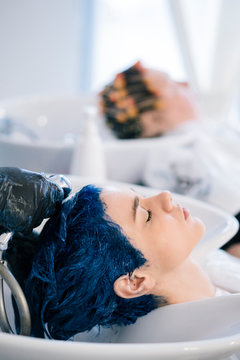 Young Woman dyeing her hair at a Salon