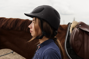 Young woman in outfit of horse rider