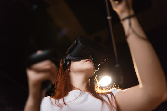 Woman gaming in VR helmet
