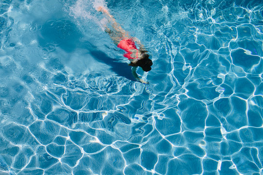 Young girl diving in a pool
