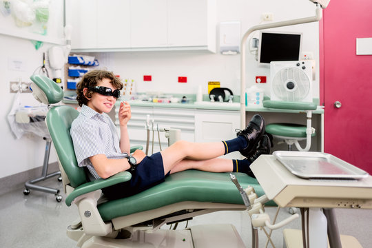 School boy waiting for treatment in a dentist chair