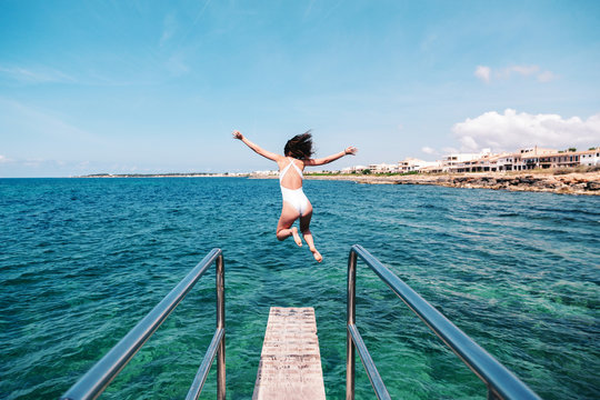 Woman jumping off a springboard