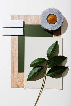 Flat lay of interior finishes, leaves and a candle
