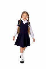  little girl seven years posing in school uniform and backpack on white isolated background .Girl preparing for school