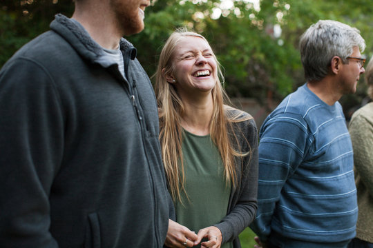 Laughing young woman with family