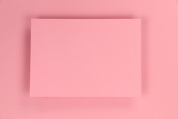 Pink paper texture background with frame in the center. Blank, photo, horizontal, free space in the center. Design and holidays concept