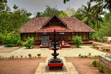 An old Kerala traditional temple with a beautiful stone lamp