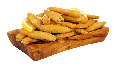 Fried bread crumb covered whitebait fish in an olive wood dish isolated on a white background
