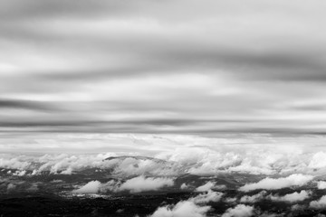 View from above of Umbria valley, with cloudscape both above and below