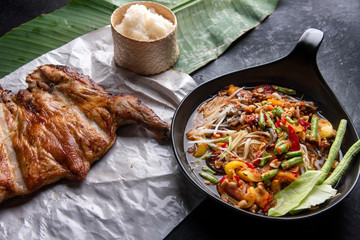 Som Tam Thai - Papaya Salad Thai Food Style on wooden tabal background. Thai Food Concept. Top View