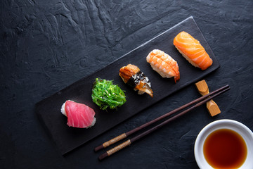 Set of sushi on dark stone table. Top view